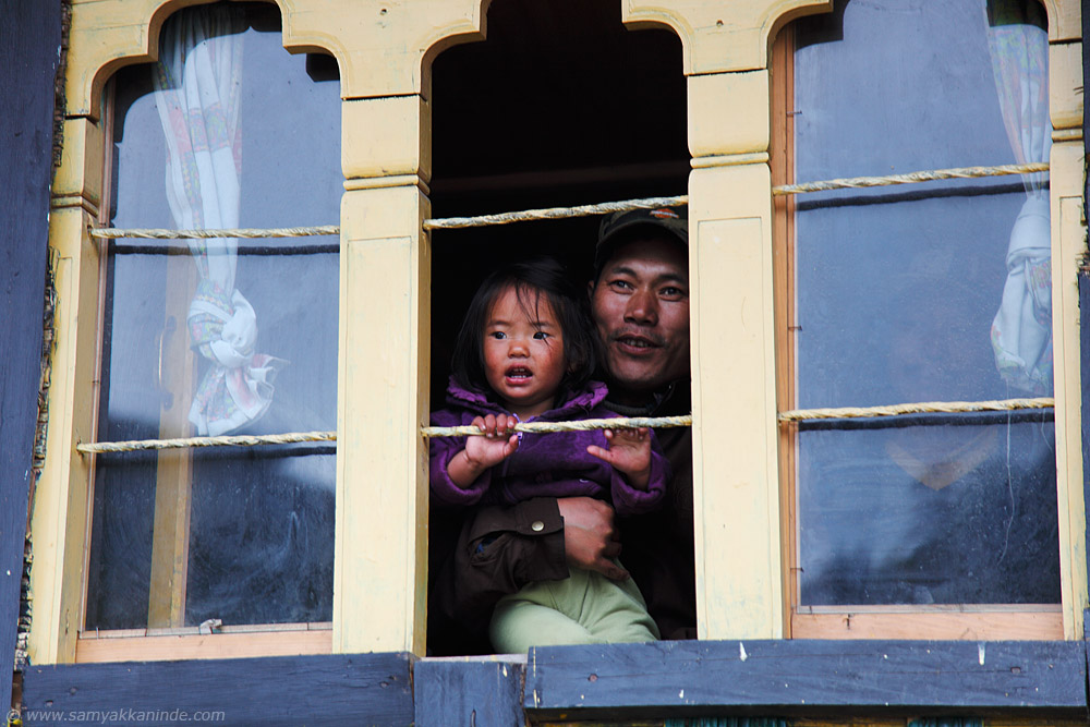 father and his daughter at pele la, bhutan.