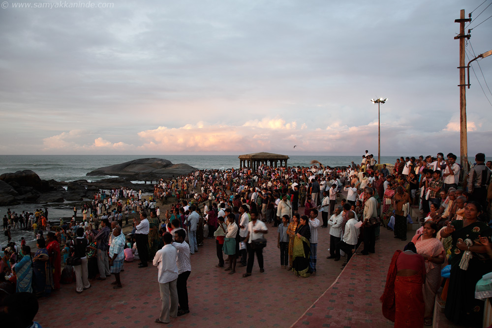 The crowd gathered at the beach to watch the sunrise.